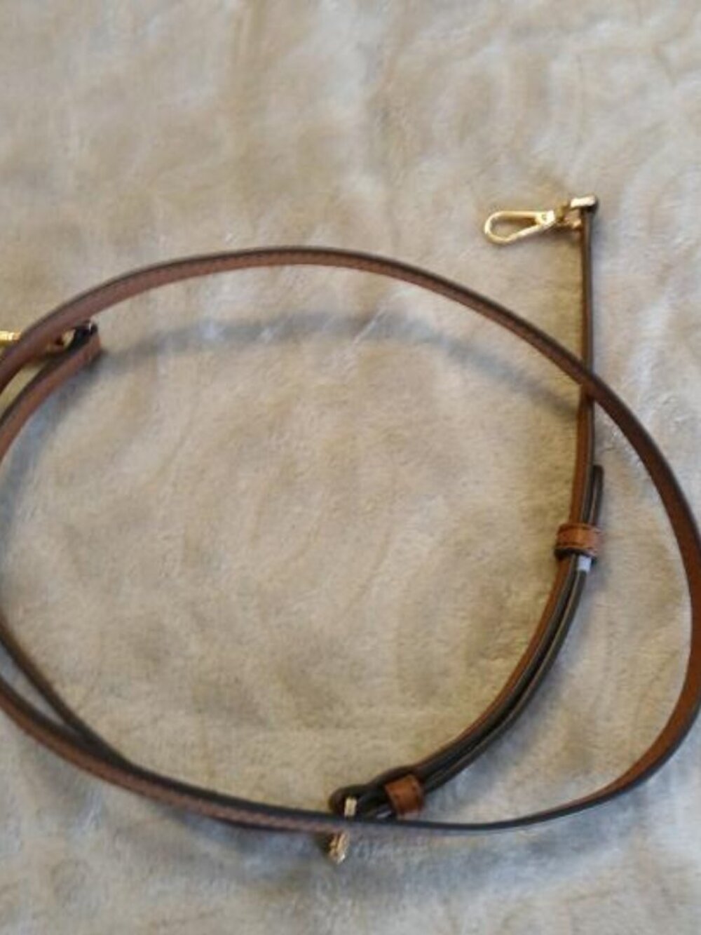 Brown adjustable strap with gold hardware